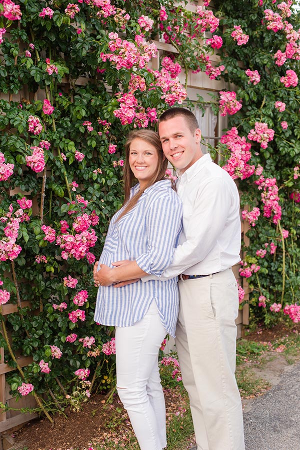 Couple in front of pink flowers by Nantucket Maternity Photographer