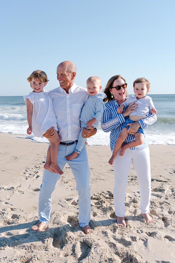 Grandparents holding grandbabies at the beach by Nantucket Family Photographer