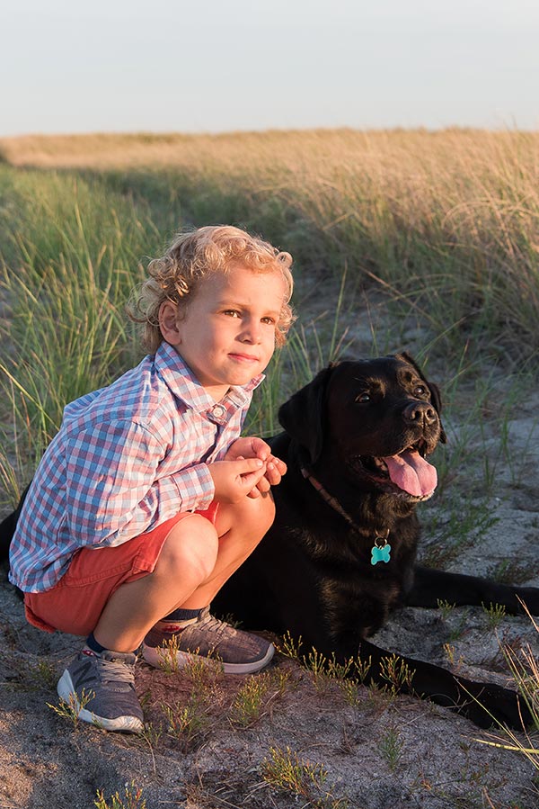 Little boy and black lab