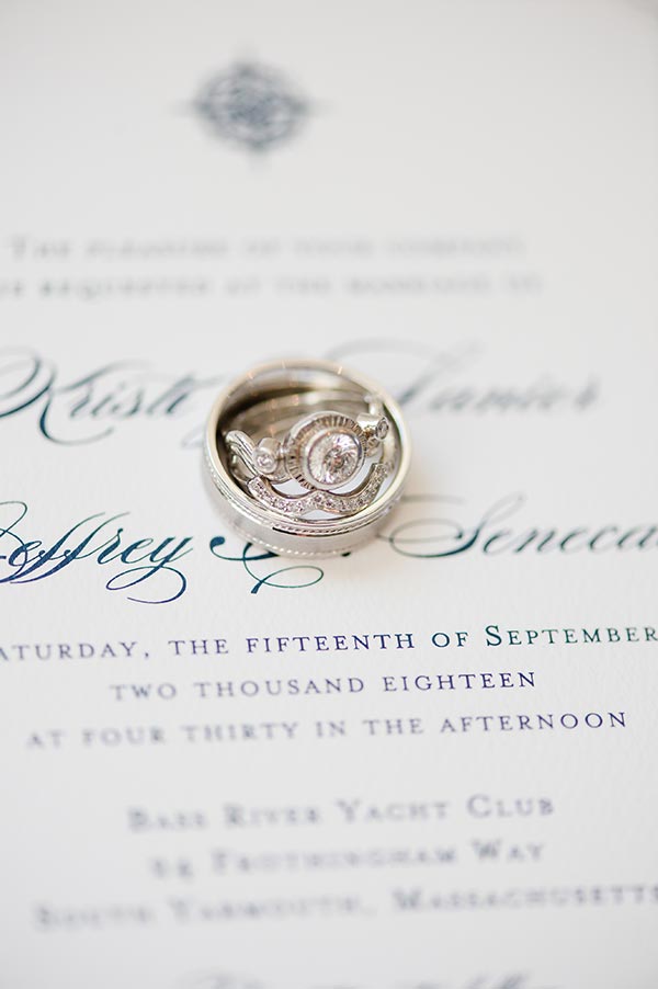 wedding rings stacked on invitation by Nantucket Wedding Photographer