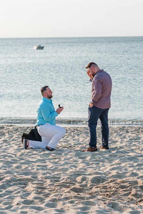 man on bended knee proposing to a man