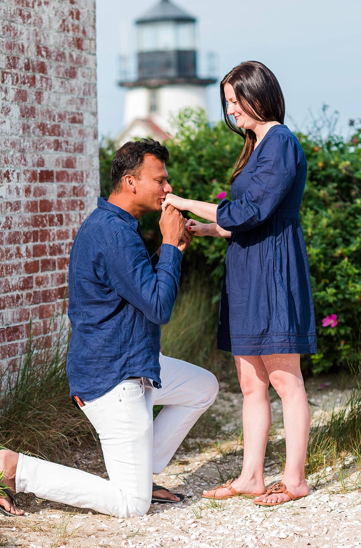man kissing womans ring finger after Nantucket Proposal